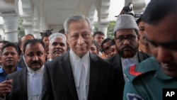 FILE - Bangladesh's Attorney General Mahbubey Alam, center, leaves court after the death sentences given to two opposition leaders for 1971 war crimes was upheld in Dhaka, Bangladesh, Nov. 18, 2015. 