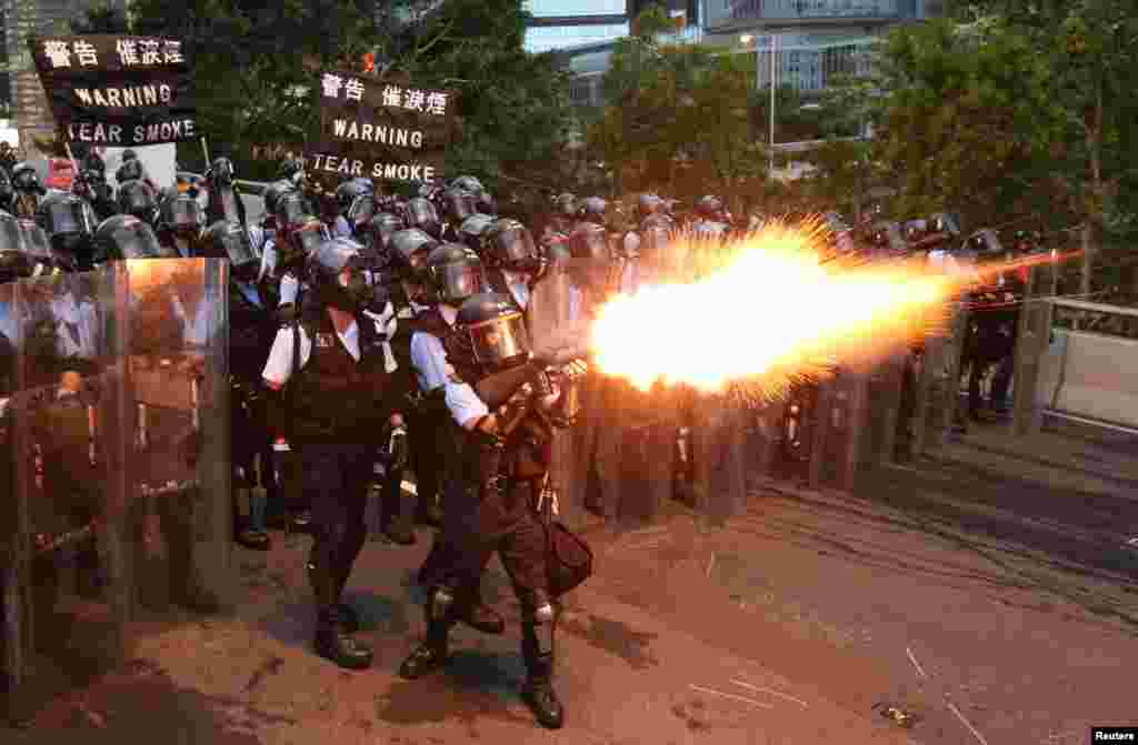 Police officers fire tear gas during a demonstration against a proposed extradition bill in Hong Kong.