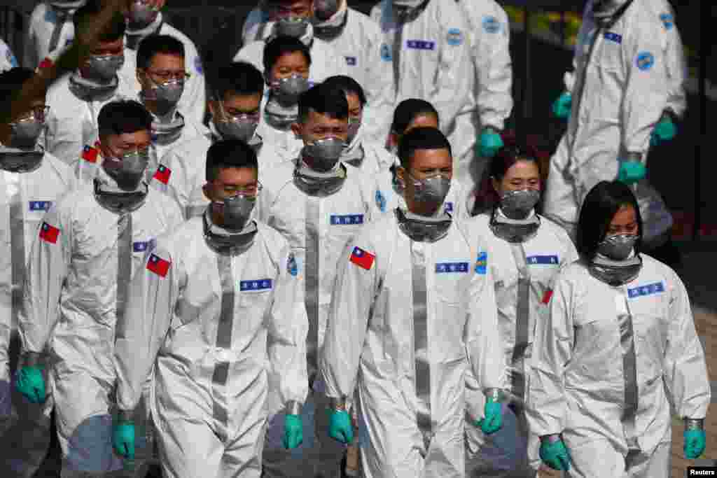 Soldiers in personal protective equipment (PPE) prepare for a visit by President Tsai Ing-wen in Taoyuan, Taiwan.