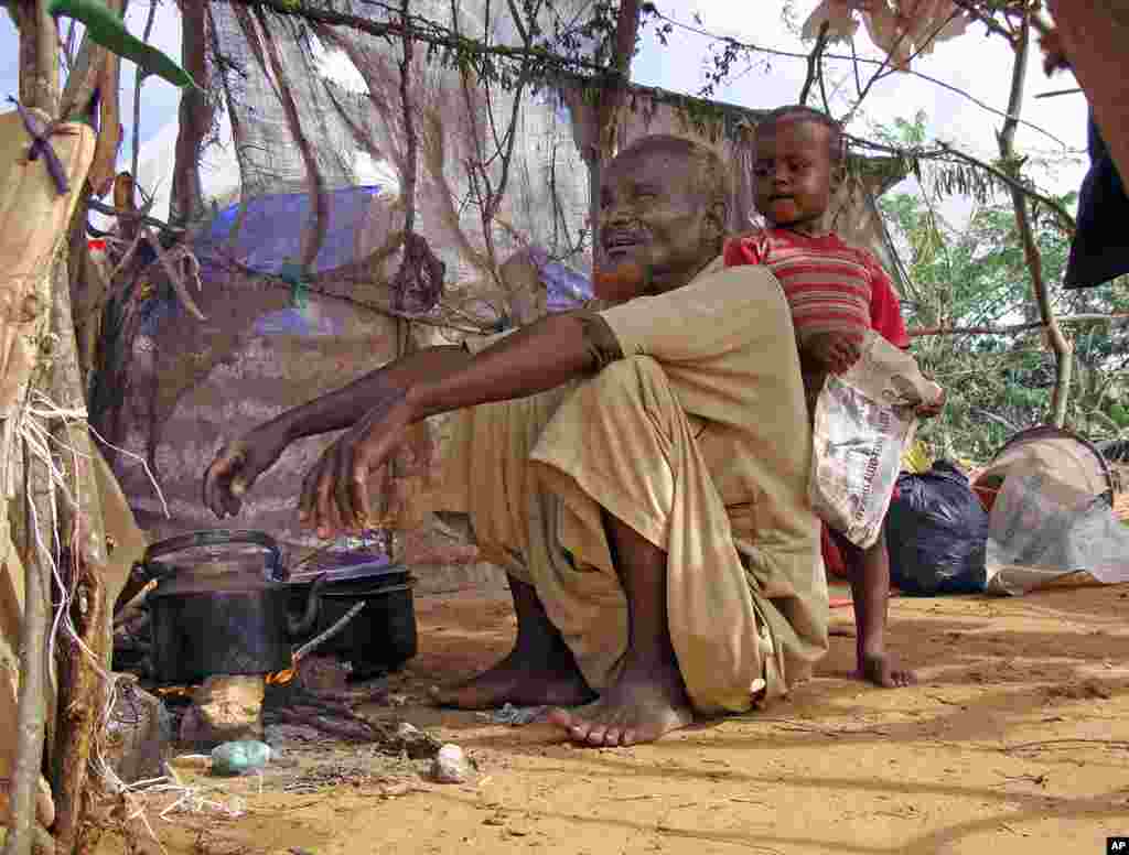 Displaced Somalian, Mohamed Idris sits in his makeshift shelter on August 4, 2011 at an Internally Displaced People (IDP) camp in southern Mogadishu. (AFP)