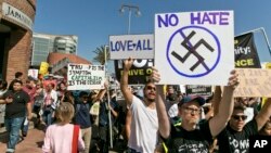 Demonstrators decrying hatred and racism following a white supremacist rally in Charlottesville, Virginia, march in downtown Los Angeles, California, Aug. 13, 2017.