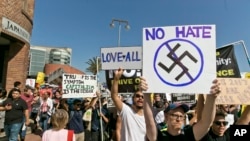 Demonstrators decrying hatred and racism following a white supremacist rally in Charlottesville, Virginia, march in downtown Los Angeles, California, Aug. 13, 2017.