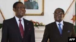 FILE: Zimbabwe President Robert Mugabe (R) poses for photos ahead of his meeting with Equatorial Guinea President Teodoro Obiang Nguema Mbasogo (L) at Zimbabwe State House in Harare, Jan. 23, 2016. 