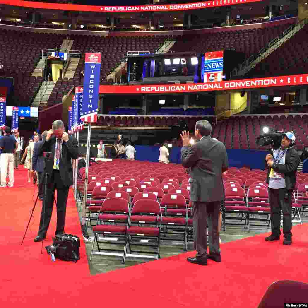 Reporters stand on the arena floor for interviews on the morning of the final day of the Republican National Convention, in Cleveland, July 21, 2016.