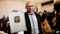 Cartoonist Lars Vilks holds the Danish Free Press Society's Sappho Prize, which he received for his efforts on behalf of freedom of speech at an meeting in the Danish Parliament at Christiansborg Castle, Copenhagen, March 14, 2015.