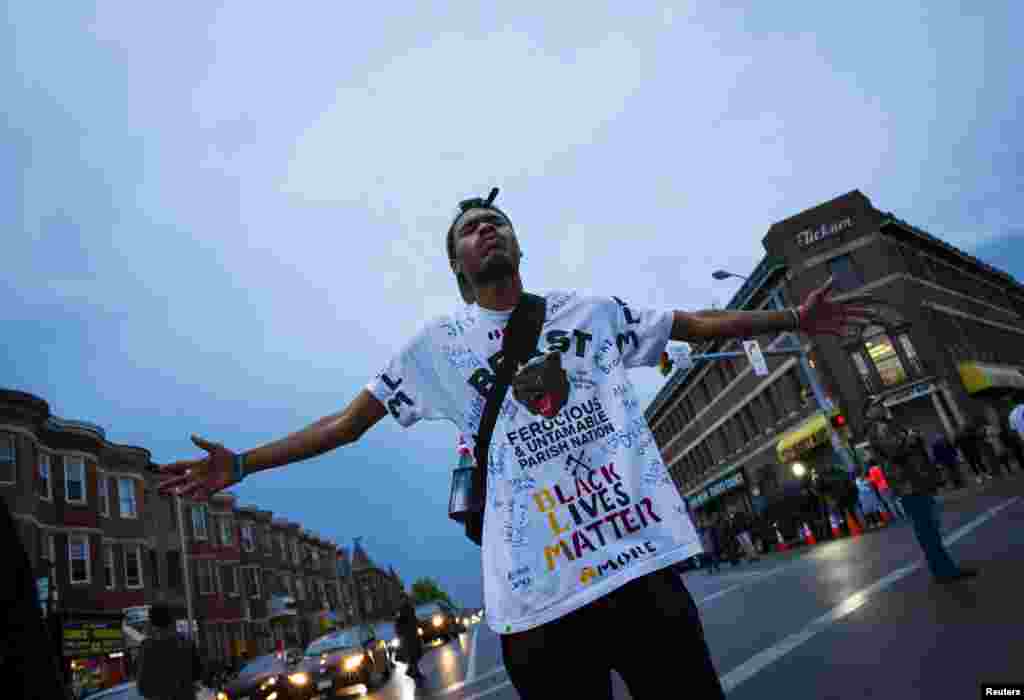 A demonstrator stands on the street at North and Pennsylvania Avenues in Baltimore, April 30, 2015.