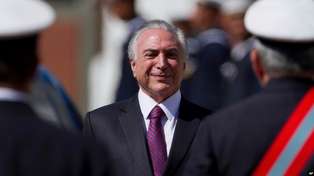 Brazil's President Michel Temer smiles as he receives military honors during a ceremony, in Brasilia, June 9, 2017.