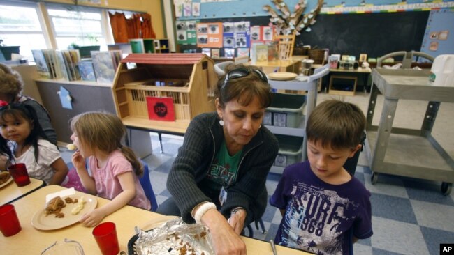 Teacher Diana Feke helps Mason Baker during lunch at the Eastham Community Center Claskamas County Children's Commission Head Start, April 9, 2012, in Oregon City.