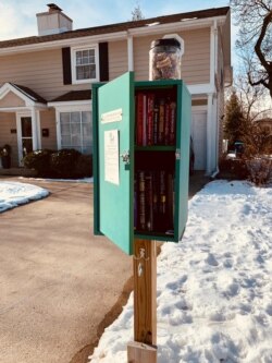 Toples berisi biskuit anjing diletakkan di atas Little Free Library di Mount Prospect, Illinois. (Courtesy: Alfred Ticoalu)