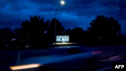 A car passes by Facebook's corporate headquarters location in Menlo Park, California, on March 21, 2018. 