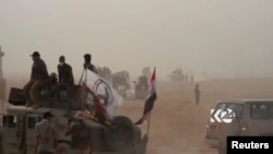 This image made from video provided by Kurdistan 24 shows an Iraqi tank moving into position as forces begun the operation to retake the town of Hawija, Iraq from the Islamic State group, Sept. 21, 2017.