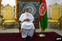 FILE - Afghan warlord and former mujahideen leader Ismail Khan looks on during an interview at his residence in Herat province, May 29, 2015.