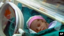 A baby girl, rescued from a building that collapsed during an earthquake, is carried in an incubator in a hospital in Ercis, near the eastern Turkish city of Van, in this still image taken from video footage October 25, 2011