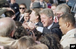 FILE - President-elect Bill Clinton and Vice President-elect Al Gore shake hands with supporters following church services in Culpeper, Virginia, Jan. 17, 1993. (AP Photo/Greg Gibson)