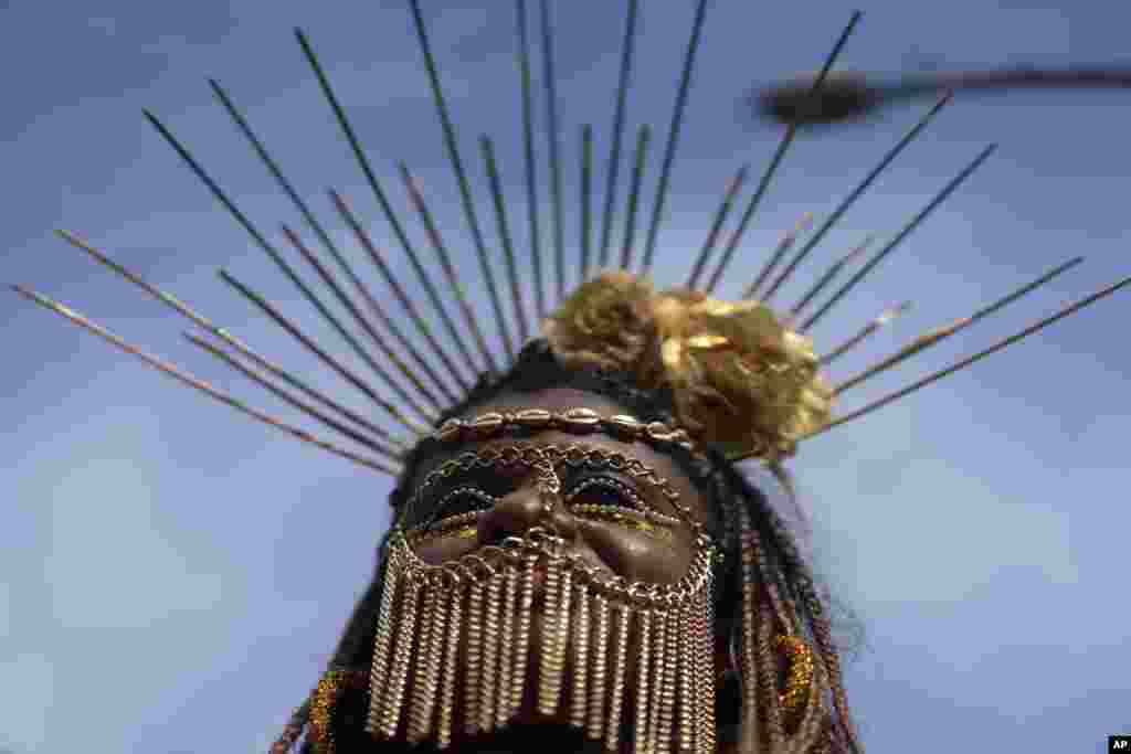 A reveler performs at the &quot;Cordao do Boitata&quot; street party, one of the many parades before the start of Carnival which begins on Feb. 21, in Rio de Janeiro, Brazil.