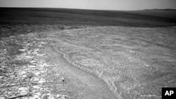 This image provided by NASA shows a fragment along the rim of Endeavour Crater where the Mars rover Opportunity has been exploring since August.