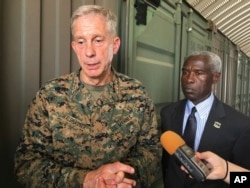 FILE - Gen. Thomas D. Waldhauser, left, commander of U.S. Africa Command, speaks in Dakar, Senegal, July 30, 2018.