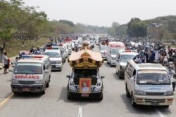 A hearse containing casket of Mya Thwet Thwet Khine travels to the cemetery in Naypyitaw, Myanmar, Sunday, Feb. 21, 2021.
