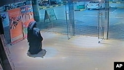 FILE - This image made from video released by the Abu Dhabi police department on Dec. 2, 2014 shows a veiled suspect in the stabbing of an American teacher in a shopping mall restroom as seen on security camera footage in Abu Dhabi, UAE. 