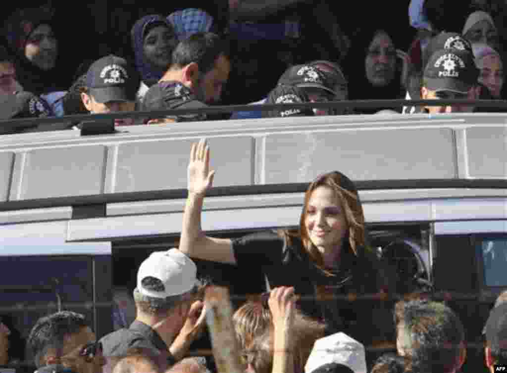 Angelina Jolie, the Hollywood celebrity and goodwill ambassador for the U.N. High Commissioner for Refugees waves as she exits a van surrounded by Syrian refugees at the Altinozu refugee camp near the Syrian border, Friday, June 17, 2011. (AP Photo/Selc