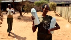 Keepers carry bottles of milk before feeding orphaned elephants, at the Reteti elephant sanctuary in Samburu county, Kenya, October 15, 2021. (REUTERS/Baz Ratner)