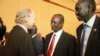 Taban Deng Gai (center), chief negotiator from South Sudan's opposition at peace talks in Addis Ababa, shakes hands with an unidentified observer. 