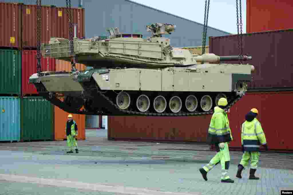 Tanks and support vehicles are transported at the military port in Vlissingen, Netherlands.