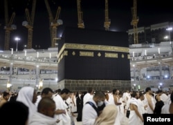 Muslim pilgrims pray around the holy Kaaba at the Grand Mosque on the first day of Eid al-Adha during the annual hajj pilgrimage in Mecca, Sept. 24, 2015.