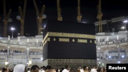 Muslim pilgrims pray around the holy Kaaba at the Grand Mosque on the first day of Eid al-Adha during the annual hajj pilgrimage in Mecca, Sept. 24, 2015.