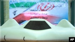 This photo released on Thursday, Dec. 8, 2011, by the Iranian Revolutionary Guards and taken at an undisclosed location claims to show the US RQ-170 Sentinel drone which Tehran says its forces downed earlier this week