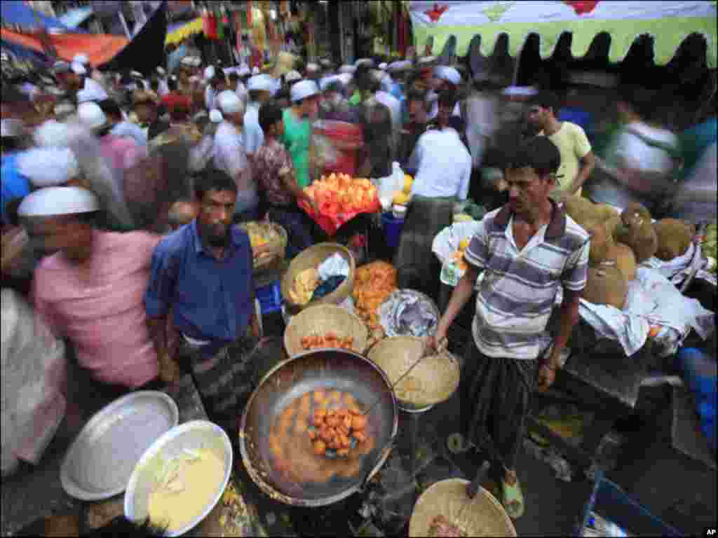 People prepare food to sell for iftar (breaking fast) at Chakbazaar during the holy month of Ramadan in Dhaka