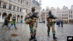 FILE - Belgium police officers patrol the Grand Place in central Brussels, Belgium, Nov. 24, 2015. 