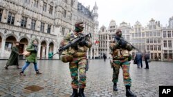 Belgium police officers patrol the Grand Place in central Brussels, Nov. 24, 2015. 