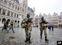 Belgium police officers patrol the Grand Place in central Brussels, Belgium, Nov. 24, 2015. The lockdown has closed the capital’s subways and schools. Officials have recommended that popular shopping districts be shuttered.