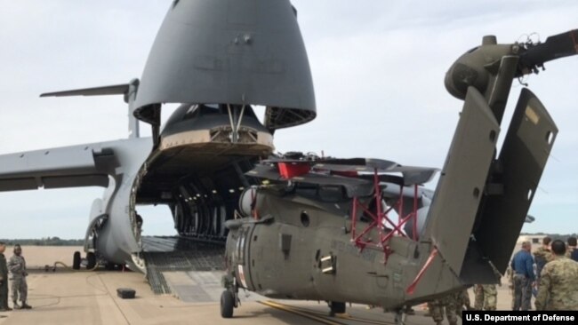 Soldiers prepare to load a Blackhawk helicopter into a C-5M Super Galaxy, Sept. 11, 2017. The helicopter is one of 35 aircraft relocating in preparation to support Hurricane Irma relief efforts.