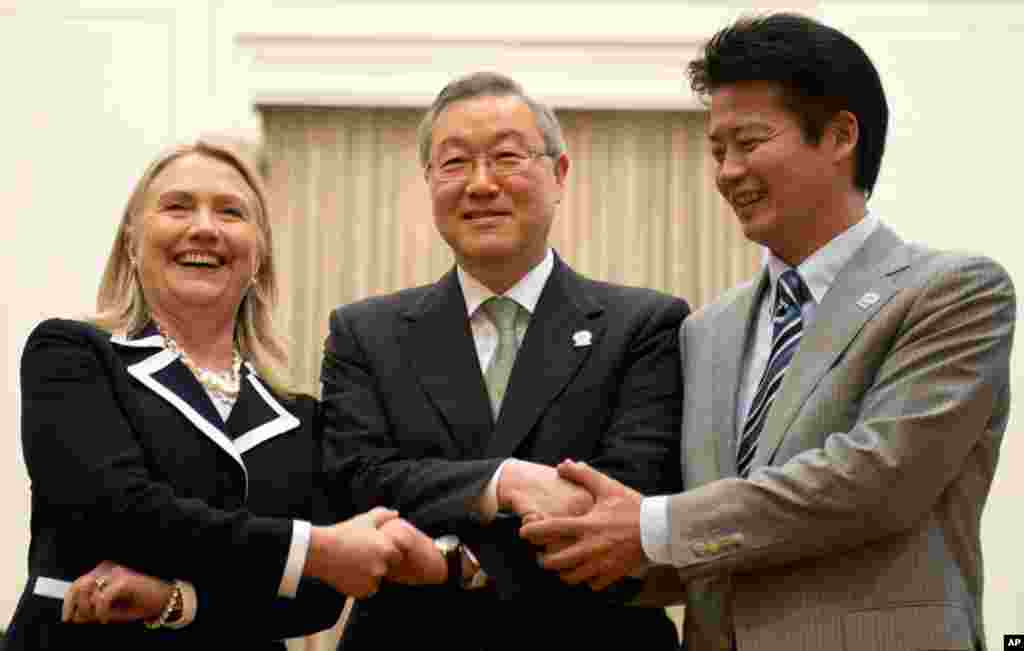 U.S. Secretary of State Hillary Clinton, left, South Korean Foreign Minister Kim Sung-hwan, center, and Japanese Foreign Minister Koichiro Gemba shake handsduring the ASEAN Regional forum in Phnom Penh, Cambodia, July 12, 2012.