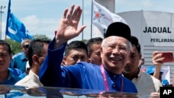 FILE - Malaysian Prime Minister Najib Razak waves to his supporters after his election nomination in Pekan, Pahang state, Malaysia, April 28, 2018.
