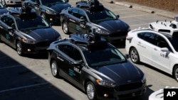 A group of self-driving Uber vehicles position themselves to take journalists on rides during a media preview at Uber's Advanced Technologies Center in Pittsburgh, Pennsylvania, Sept. 12, 2016.