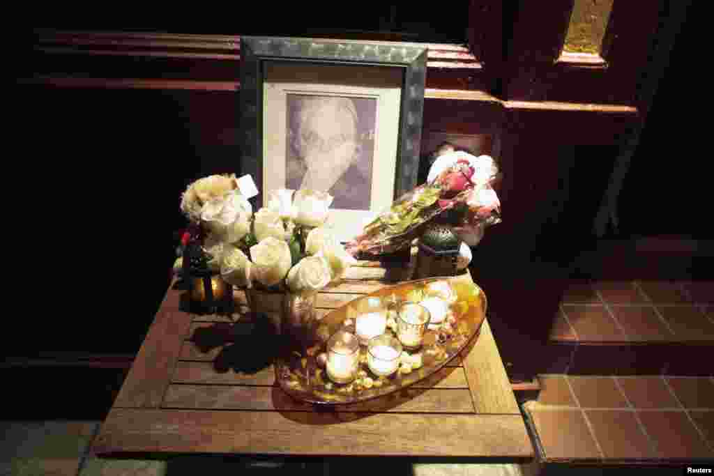 A portrait and flowers in memory of actor Philip Seymour Hoffman is displayed outside Philip Marie Restaurant and bar on Hudson Street in Manhattan, New York, Feb. 2, 2014.