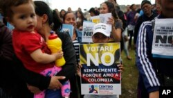 File -- Opponents to the peace deal signed between the Colombia government and rebels of the Revolutionary Armed Forces of Colombia promote the "No" vote in Oct. 1, 2016, referendum in Bogota, Colombia. Colombians narrowly rejected the deal. 