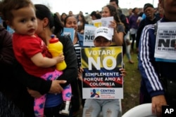 Opponents to the peace deal signed between the Colombia government and rebels of the Revolutionary Armed Forces of Colombia, FARC, attend an event to promote the "No" vote in the upcoming referendum in Bogota, Colombia, Oct 1, 2016.