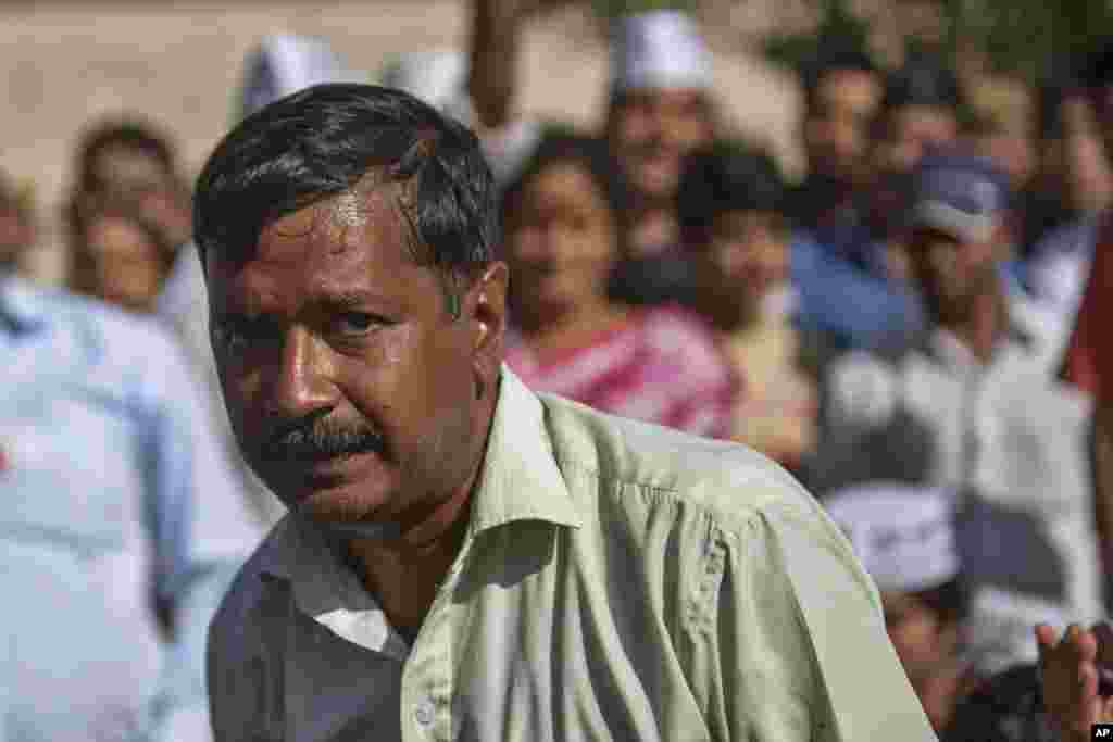 Aam Aadmi Party (AAP), or common man party, chief Arvind Kejriwal sits with supporters at Rajghat, the memorial of Mahatma Gandhi after he was slapped by an attacker during his election campaign in New Delhi, India, Tuesday, April, 8, 2014. The AAP party 