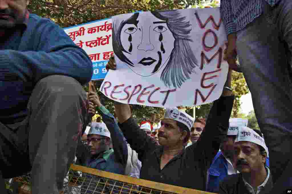 Supporters of the Aam Aadmi, or Common Man, Party (AAP) hold placards during a protest after a woman was allegedly raped by a taxi driver in New Delhi, India, Monday, Dec. 8, 2014.