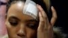 Gabriella Engels touches her head during a media conference in Pretoria, South Africa, Aug. 17, 2017.