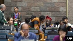 Delegates interact during a break in the closing plenary of the Third session of the Intergovernmental Negotiating Committee on Plastic Pollution (INC-3) at the United Nations Office (UNON) in Nairobi on November 19, 2023. 