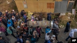 Kashmiris walk in the funeral procession of Mohd Ibrahim Khan during his funeral in Srinagar, Indian controlled Kashmir, Nov. 9, 2021. Gunmen shot and killed Khan, a salesman by profession, in Indian portion of Kashmir, police said. 