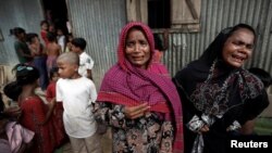 Rohingya refugees react before the funeral of a family member, who they say succumbed to injuries inflicted by the Myanmar Army before their arrival, in Cox's Bazar, Bangladesh, Sept. 29, 2017.