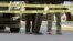 A gun lies on the ground inside a police barricade following a shooting at a Kroger grocery that left two people dead and a suspect in custody in Jeffersontown, Ky., Oct. 24, 2018.