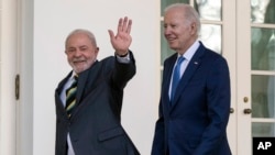 Los presidentes de Brasil, Luiz Inácio Lula da Silva (izq) y de Estados Unidos, Joe Biden, saludan a la prensa antes de entrar al Despacho Oval de la Casa Blanca, Washington, el 10 de febrero de 2023