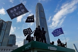 Protesters wave flags that read "Hong Kong Independence" during a rally in Hong Kong, Jan. 12, 2020.